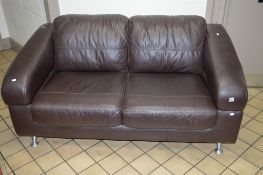 A BROWN LEATHER TWO SEATER SETTEE