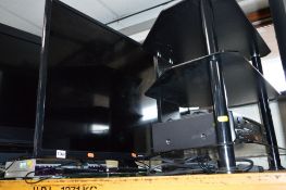A POLAROID LE 40GCL-Y 40' LED TV, a glass TV stand, etc (remote) (3)