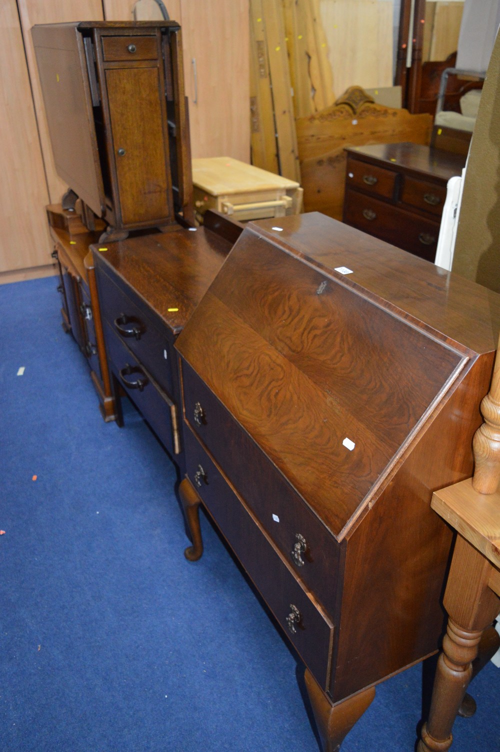 A WALNUT FALL FRONT BUREAU, an oak chest of two drawers, a walnut dressing table and an oak cupboard