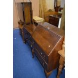 A WALNUT FALL FRONT BUREAU, an oak chest of two drawers, a walnut dressing table and an oak cupboard