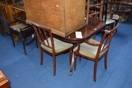 A MAHOGANY PEDESTAL TABLE, one extra leaf, with four chairs and a wall unit (6)