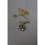 A 9CT PEARL GEM SET FLOWER PENDANT AND CHAIN, approximate weight 3.3 grams