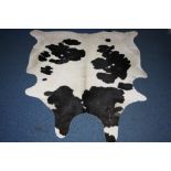 A COW HIDE RUG, originated from South America, AA grade black and white ground, approximate size