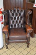 A LEATHER BUTTONED WING BACK ARMCHAIR, approximate size inner arm width 49cm x height 106cm