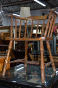 AN EARLY 20TH CENTURY FRUITWOOD CAPTAINS CHAIR, with spindle back (sd)