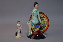 A BOXED KEVIN FRANCIS CERAMICS LIMITED EDITION FIGURE, 'Young Clarice Cliff' seated on a teacup