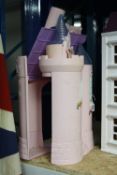 A PINK PLASTIC TOY CASTLE, opens to reveal interior, approximate height 59cm