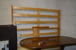 A PINE 4' 6' BED FRAME, with leather look head rests