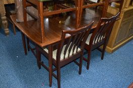 A TEAK EXTENDING TABLE, four leatherette chairs (one with replacement legs) and four mahogany dining