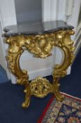 A GILTWOOD CONSOLE TABLE, white veined black marble serpentine top, on a foliate carved cabriole