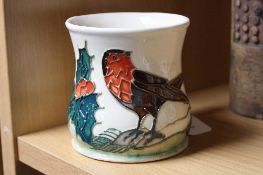 A MOORCROFT POTTERY TAPERED MUG, tube line decorated with Robin and Holly, impressed and painted