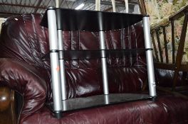 A BLACK GLASS TV STAND, and a large metal deed box (2)