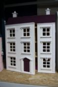 A MODERN WOODEN DOLLS HOUSE, modelled as a three storey Georgian town house, front opening to reveal