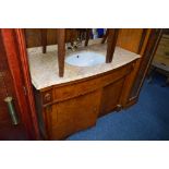 A BURR WALNUT FINISH WASH BASIN, with marble top, sink and brass tap above a double cupboard base,