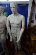 A FULL LENGTH MALE SHOP DISPLAY MANNEQUIN, on a seperate glass stand, approximate height 185cm