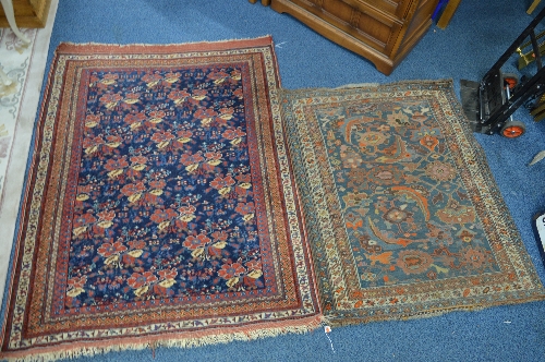 AN EARLY 20TH CENTURY CAUCASION WOOLLEN RUG, red and blue ground, multi strap border, floral