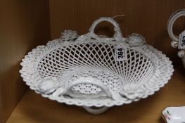 A FRETWORK CERAMIC BASKET, florally encrusted, diameter approximately 27.5cm (chips to edges)