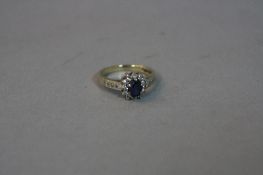 A LATE 20TH CENTURY 9CT GOLD DIAMOND AND SYNTHETIC SAPPHIRE CLUSTER RING, an oval cluster ring