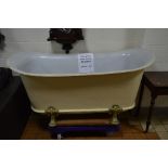 A VICTORIAN CAST IRON DOUBLE ENDED ROLL TOP BATH, white enamel interior, on four short cabriole legs