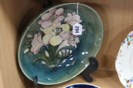 A LARGE MOORCROFT POTTERY FOOTED BOWL, Orchid (?) pattern on green ground, impressed and painted