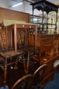 AN EBONISED TWO TIER OCCASIONAL TABLE, and four wheel back chairs (5)