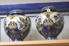 A PAIR ROZENBURG DEN HAAG BULBOUS VASES, painted with bird and foliage and glazed, painted factory
