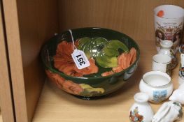 A MOORCROFT POTTERY FOOTED BOWL, 'Hibiscus' pattern on green ground, impressed and painted marks