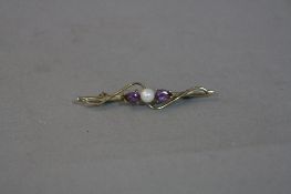 AN EDWARDIAN AMETHYST AND SEED PEARL BAR BROOCH, (boxed)