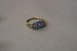 A 9CT TANZANITE AND DIAMOND MARCASITE CLUSTER RING, ring size Q, approximate weight 2.6 grams