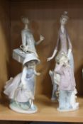TWO LLADRO FIGURINES, lady with dog and parasol (missing finger) and lady with present (missing