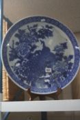 A LATE 19TH CENTURY JAPANESE BLUE AND WHITE CHARGER, decorated with a Peacock, diameter 46cm