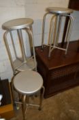 A SET OF FOUR SOUTHERN BROS MEDICAL STOOLS, on four metal legs and pressed steel revolving top