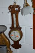 AN OAK ANEROID BAROMETER, marked J W Cassidy and an oak mantle clock (2)