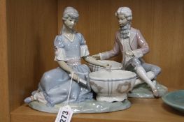 A PAIR OF BOXED LLADRO FIGURAL SALTS, 'Nina Joyero' No 713 and 'Nino Joyero' No 714 (finger re-