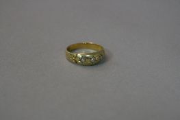 AN 18CT THREE STONE DIAMOND SET GYPSY RING, ring size N, approximate weight 3.3 grams