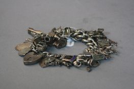 A SILVER CHARM BRACELET, approximate weight 109 grams