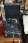 A PORTABLE WIND UP GRAMOPHONE (sd)