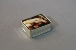 A SILVER ENAMELLED PILL BOX, with female nude on the front