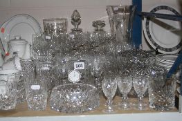 A QUANTITY CUT/ETCHED GLASS, to include Waterford timepiece, decanters, vases, glasses etc