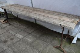 TWO VICTORIAN CAST IRON TRESTLE STANDS, with four lengths of timber, approximate length 293cm
