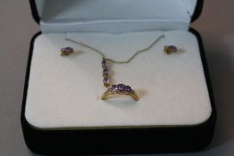 A 9CT TANZANITE JEWELLERY SUITE, to include ring, ring size O, pendant and a pair of earrings