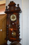 A WALNUT VIENNA WALL CLOCK, circular dial and roman numerals, (losses) (winding key)