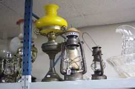 AN OIL LAMP, TWO DAVY LAMPS AND A LIGHT HOUSE LAMP (4)