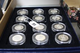 A SET OF TWELVE SILVER FIFTY PENCE PIECES