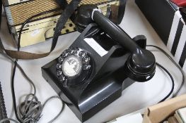 A BLACK BAKELITE TELEPHONE