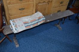 AN EARLY 20TH CENTURY PINE RAILWAY BENCH, on cast iron frame, marked Hawes, approximate length