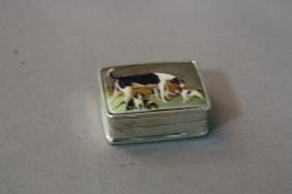 A SILVER ENAMEL BOX, depicting mother and her four pups