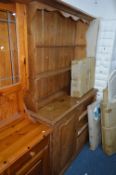 A VICTORIAN PINE SIDEBOARD, with three drawers and one door and a more recent pine plate rack
