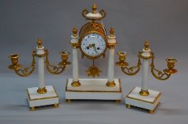 A LATE 19TH CENTURY WHITE MARBLE AND GILT METAL CLOCK GARNITURE, the clock with urn finial and bow