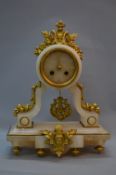 A LATE 19TH CENTURY FRENCH EIGHT DAY ALABASTER MANTEL CLOCK, the drum head with gilt metal mask